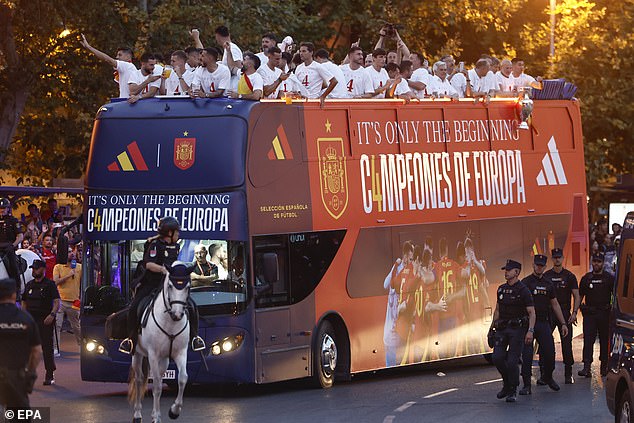 The players were surrounded by thousands of celebrating fans and a heavy police presence escorted the bus.