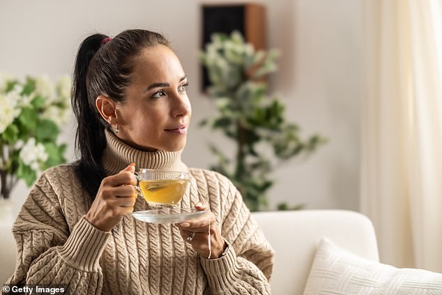 It may be tempting to grab a cup of coffee for a caffeine boost, but experts suggest it's better to opt for chamomile tea (photo: stock image)