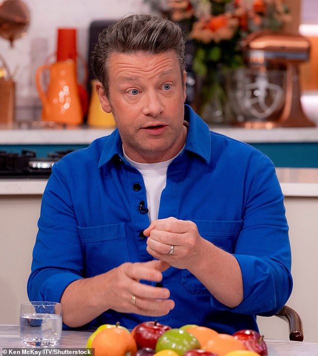 He also presents a cake to Jamie Oliver (pictured) on the set of Masterchef Australia and appears in many other wild and wonderful locations.