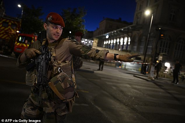 Paris is currently on the highest possible security alert level as it prepares to welcome millions of people for the 2024 Summer Olympics, which begin later this month. Pictured: A soldier outside Gare de l'Est station after the knife attack