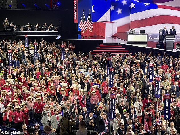 A crowd of Republican National Convention attendees turn to smile for the cameras as the event begins on Monday.