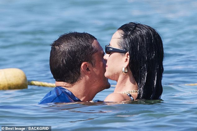 The couple was spotted showing off their PDA in the sea.