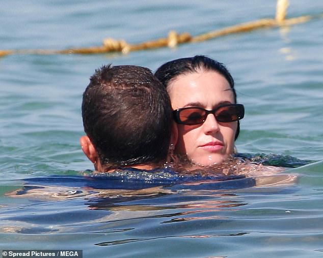 Katy was seen hugging her partner in the sea