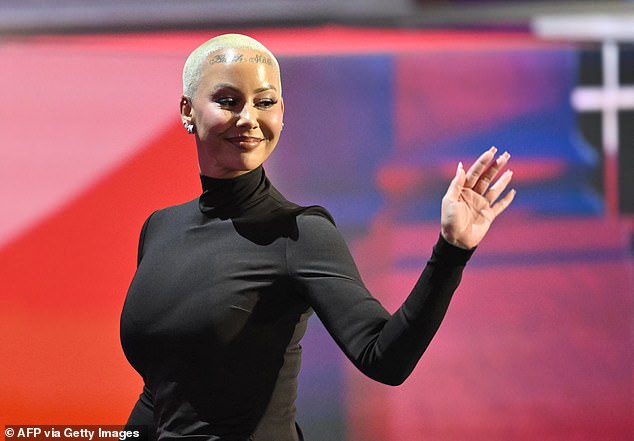 Amber Rose waves to the crowd attending the Republican National Convention in Milwaukee on Monday night after announcing her support for former President Donald Trump's candidacy.