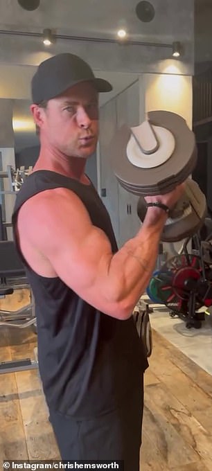 Chris effortlessly lifted a pair of hand weights and took time between reps to promote a workout program from his Centr Fitness app.