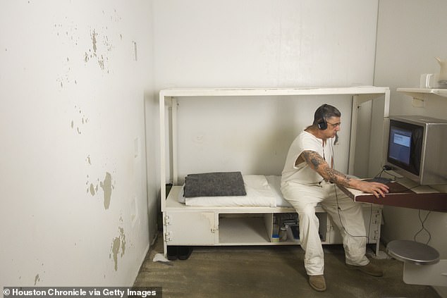 An inmate works on a computer in his cell in the administrative segregation wing of the Estelle Unit (file photo)