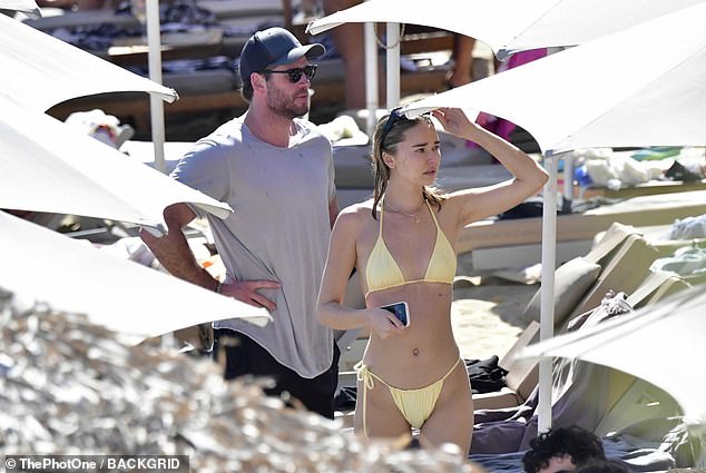 The beauty wore a delicate gold necklace to complement her swimsuit.