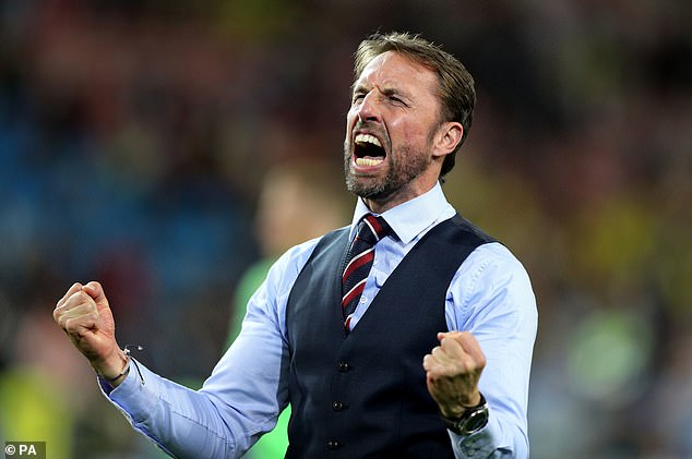 Southgate celebrates with England supporters after the Three Lions won their first World Cup penalty shoot-out against Colombia in 2018 to advance to the quarter-finals.