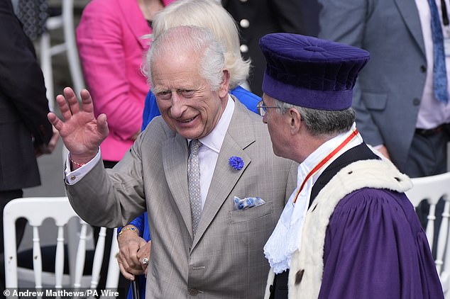 King Charles greets his supporters as he arrives at the Guernsey Parliament in St Peter Port on Tuesday