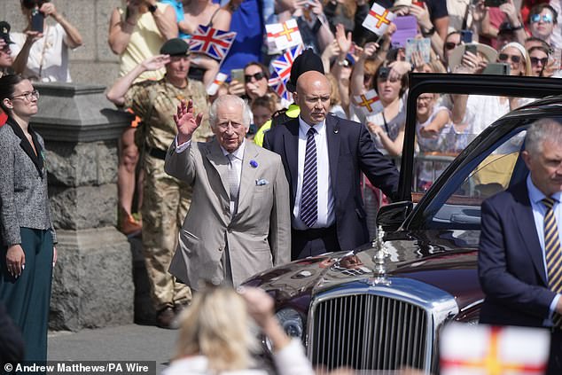 Stepping out of his royal carriage, the King raised his hand to greet those gathered on Tuesday.