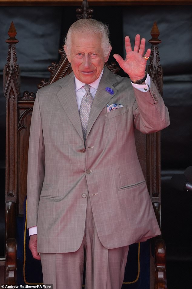 The King waves during the first official royal visit by a monarch to the Channel Islands since 2005