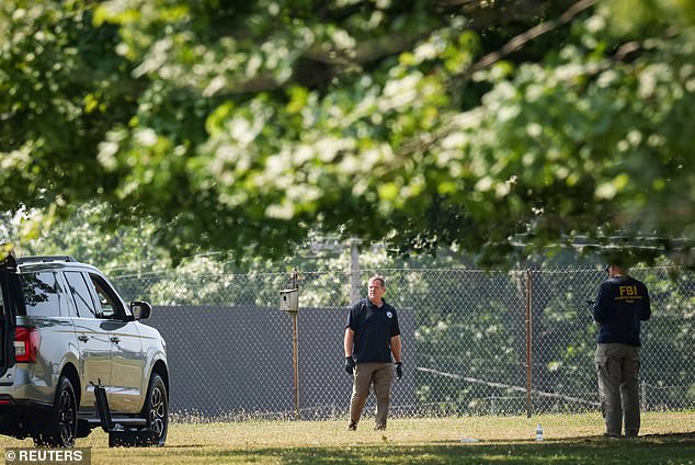 Members of the FBI's Evidence Response Team work near the building where Crooks was shot and killed by police.