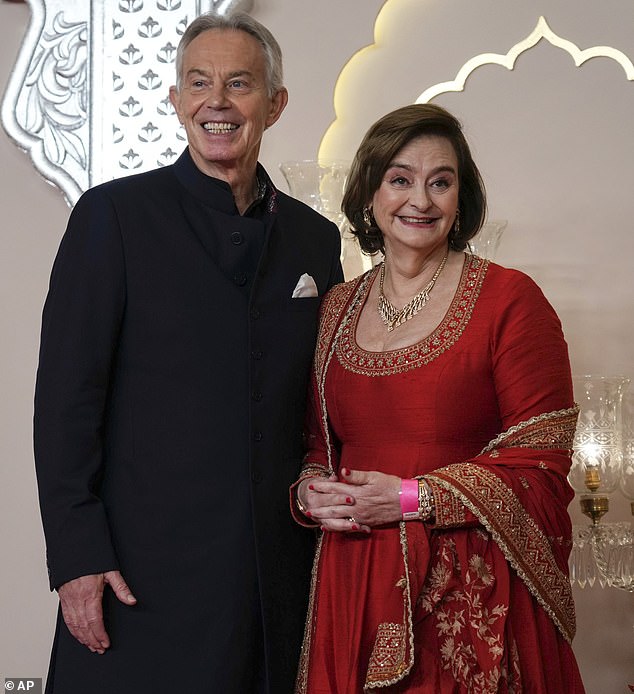 Cherie Blair was among the other guests who wore red for the wedding celebrations (pictured with Tony Blair)