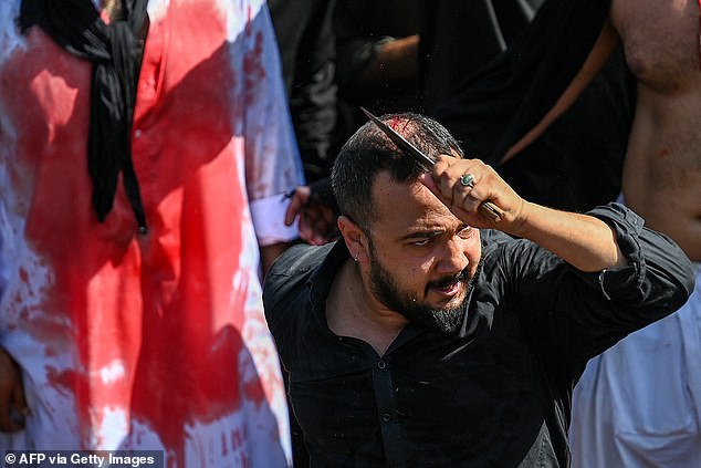 A Shia Muslim flagellates himself during a religious procession on the ninth day of the Islamic month of Muharram, in Islamabad today