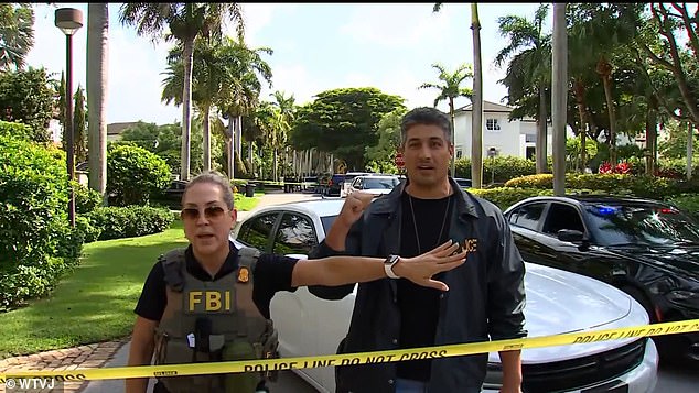 The developer's home and offices were also searched in June. FBI agents pictured Tuesday