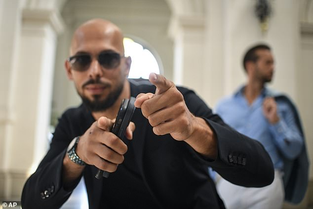 Tate poses at the Bucharest Court of Appeals before it overturned a July 5 ruling that allowed him and his brother to leave Romanian territory as long as they remained within the European Union, while awaiting trial on charges of human trafficking, rape and forming a criminal gang to sexually exploit women.