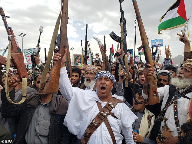 The Yemen-based Houthi group has been attacking ships in the Red Sea and the Gulf of Aden for the past nine months, claiming its actions are a direct response to Israel's war against Hamas in Gaza. Pictured: Houthi supporters in May