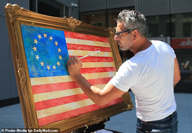 The Trump-supporting artist is known for his depictions of the American flag. Pictured: LoBaido painting the Betsy Ross American flag in front of Nike headquarters in New York