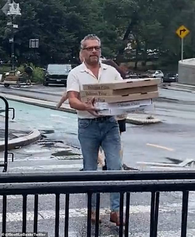 Scott LoBaido marched to the doors of New York City Hall before throwing slices of Margherita pizza at them in protest against a proposed new emissions law.