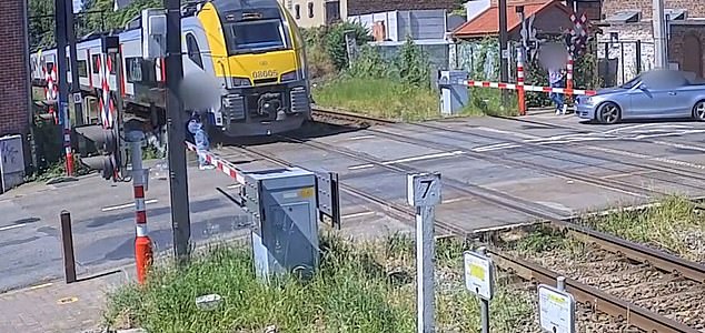 At the end of the clip, the cyclist can be seen talking to a driver in a car that has stopped at the barriers.