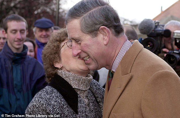 Prince Charles receives a kiss from a royal admirer during his visit to York to see flood damage, 2000