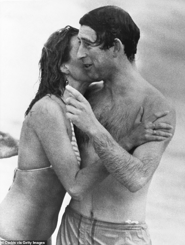 Prince Charles is kissed by Jane Priest, a model, as he emerges from the water at Cottesloe Beach in Perth, during his tour of Australia in 1979.