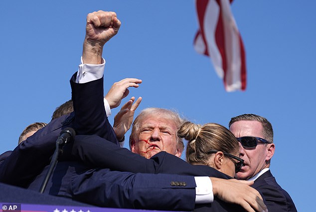 As Trump raised his fist toward the crowd, some were heard cheering his name and chanting 