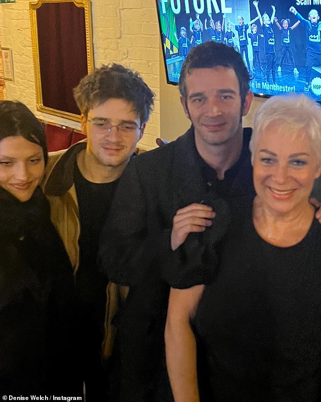 After five months together, the frontman (centre-right) introduced his model girlfriend (left) to his parents Denise Welch (right) and Tim Healy (Matty's brother Louis, pictured centre-left).