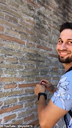 A passerby filmed Mr Dimitrov as he carved the names into the stone walls.