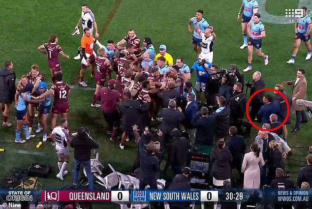 In sensational scenes, New South Wales' 19th man Haumole Olakau'atu (pictured right, circled in red) was forced off the Suncorp Stadium sideline after becoming involved in a first-half brawl.