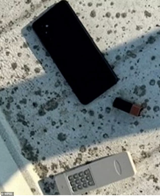 The remote detonator is seen next to Thomas Crooks' mobile phone