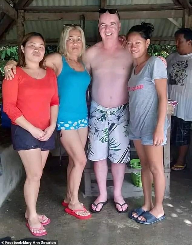 The three murder victims are pictured left and center with another family member (right) during Fisk's visit to the Philippines with his partner Lucita Barquin Cortez.