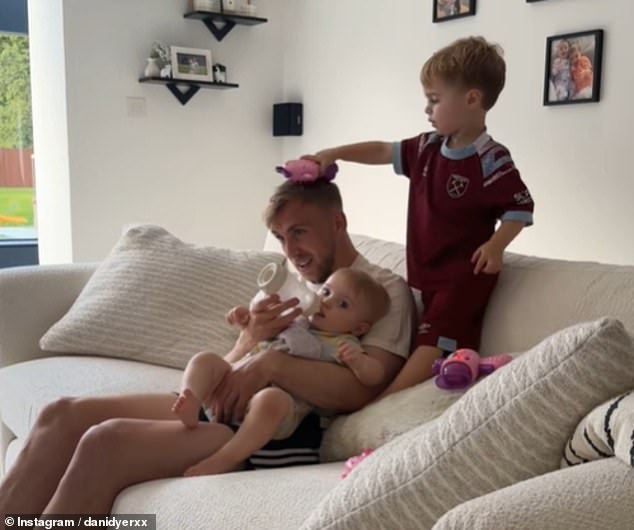 In the adorable clip, Jarrod - who shares twins Summer and Star, 13 months, with Dani - was feeding one of the little ones, while the Love Island star's son Santiago, three, brushed his hair.