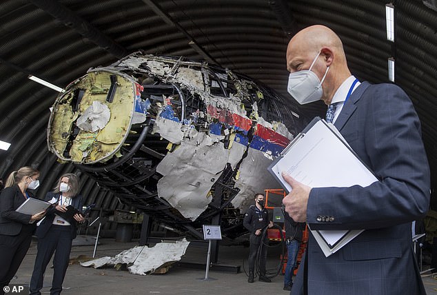 Pictured: The reconstructed wreckage of MH17 at a military base in the Netherlands in 2021