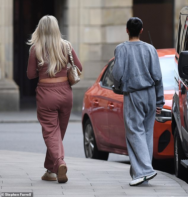 She completed the casual ensemble with a pair of beige striped sneakers and styled her blonde locks in loose waves for the outing.