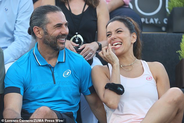 She was also photographed laughing with a friend while sitting courtside watching other celebrities and professionals battle it out on the court.