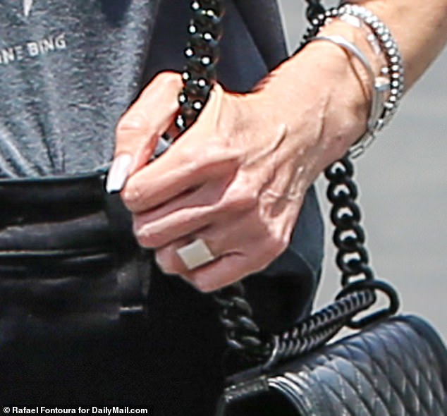 In exclusive photos from DailyMail.com, the star sported a bandage on her ring finger as she tried to put her marital split behind her.