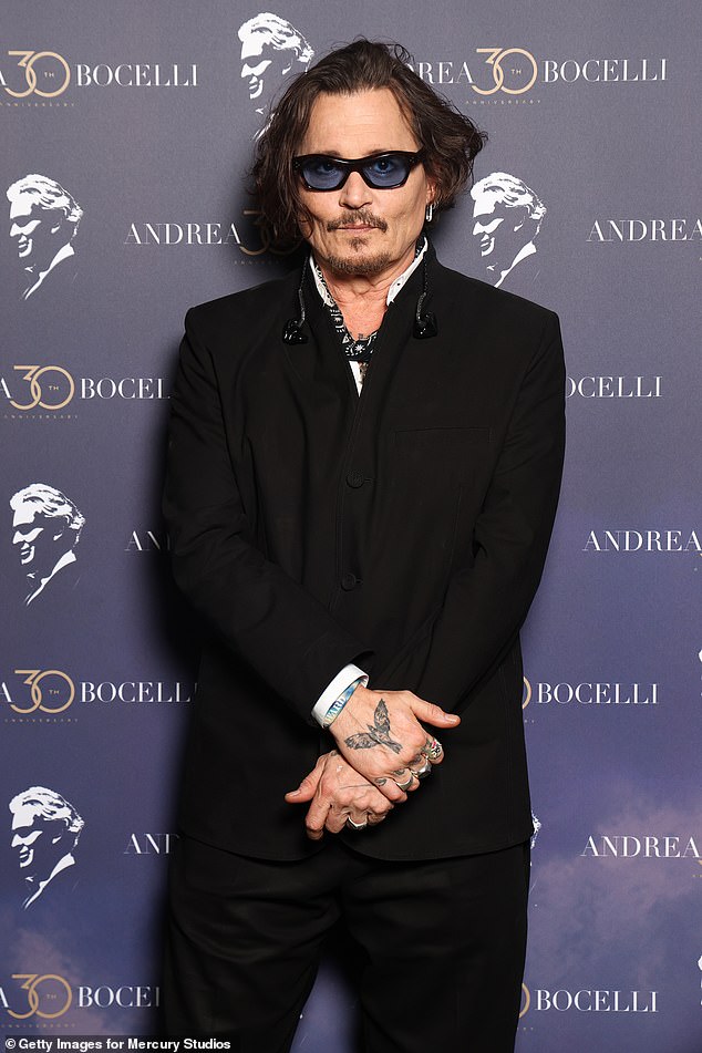 He completed the look with thick black sunglasses with blue lenses, and wore his dark hair shaggy while sporting a goatee.