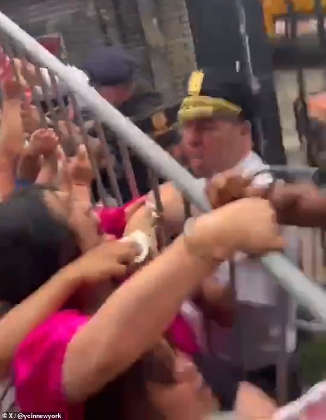 Police could be seen struggling with Zhuang and several other protesters over a metal barricade, and at one point appeared to lift it.