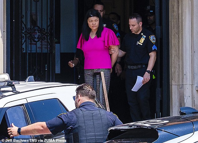 Brooklyn City Councilwoman Susan Zhuang, arrested during a protest, is taken away by officers from the 62nd Precinct in Bath Beach to be transported to Brooklyn Central Booking