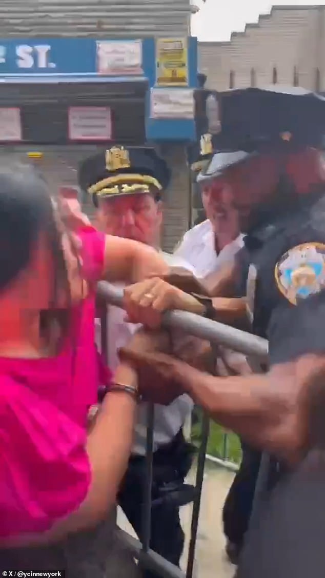 Several officers attempted to handcuff Zhuang during the fierce protest.