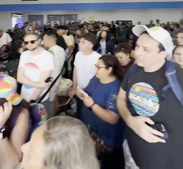 The clip, recorded by a nearby passenger, showed a massive crowd of passengers gathered around a gate as overwhelmed Spirit employees panicked.