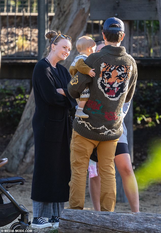 His wife Jordan also dressed for comfort in a black coat and sneakers.