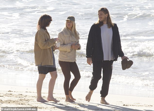 After their loving display, the couple enjoyed a stroll with a friend.