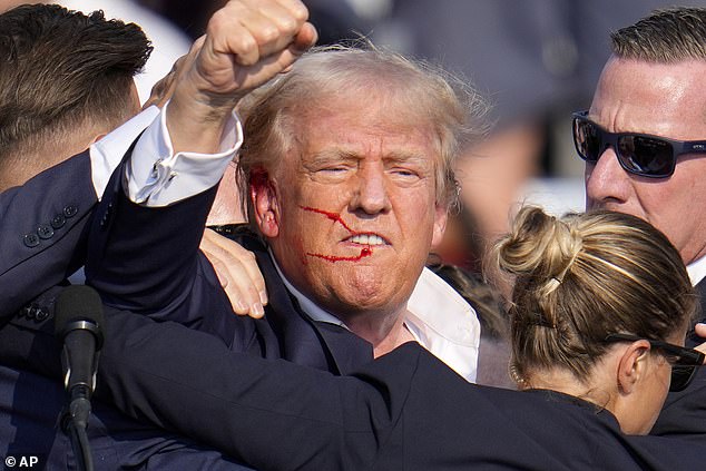 The former president, covered in blood from the bullet that grazed his ear, raises his fist at the event in Pennsylvania on Saturday