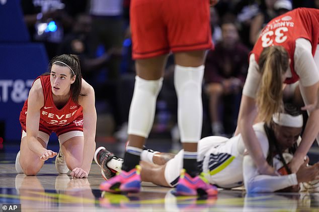 Clark, left, looks toward the bench after being stripped of the ball that Sims recovered.