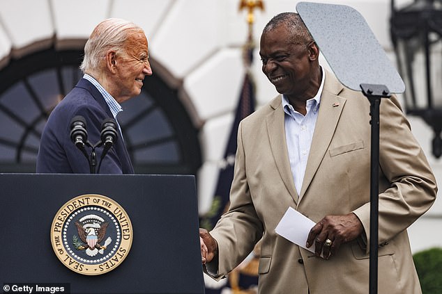 President Joe Biden shakes hands with Secretary of Defense Lloyd Austin before speaking during a Fourth of July event on the South Lawn of the White House July 4, 2024 in Washington, DC.