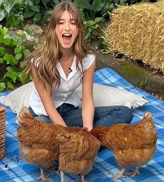 Daisy Edgar Jones poses with chickens at Spitalfields City Farm in London