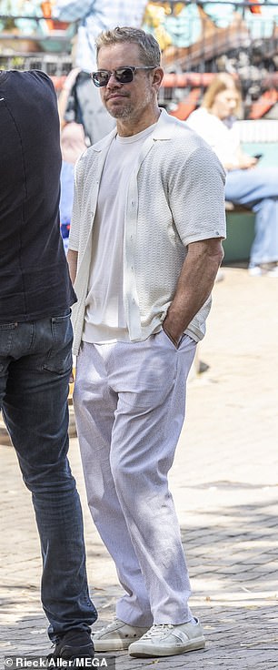 Meanwhile, Matt looked summery in an all-white outfit as he chatted with a friend.