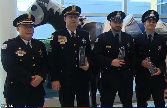 In 2019, a video shows Dakuras, second from left, being honored alongside two other officers.